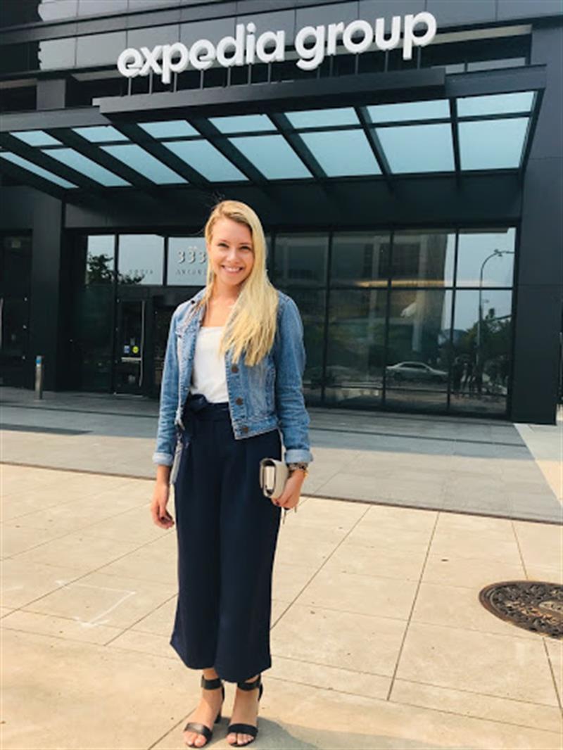 UD alumna Sarah Fritz stands in front of the Expedia Group in Washington, D.C., where she works as a government affairs coordinator.